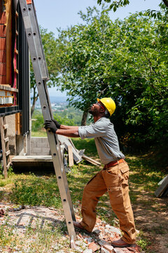 Construction Worker Climbing Ladder