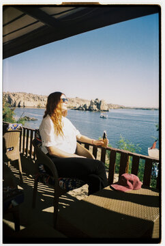 Woman enjoy drink by Nile River