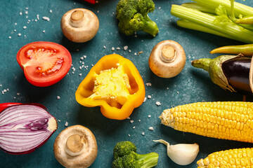 Fresh ripe vegetables on green background, closeup