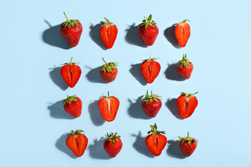 Many fresh strawberries on blue background