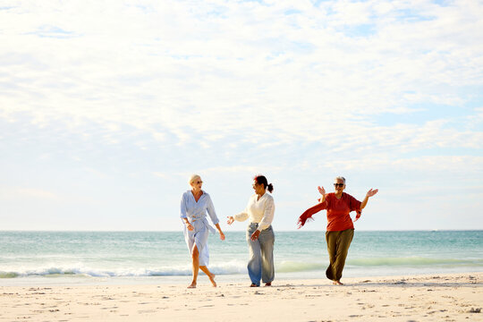 Friends Walk Together on the Beach