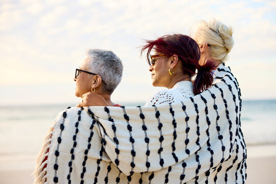 Women Enjoying Time by the Beach During Sunset