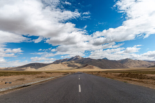 Open road leading through arid Himalayan landscape