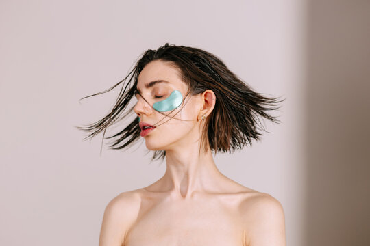 Woman with eye patches Shaking Hair