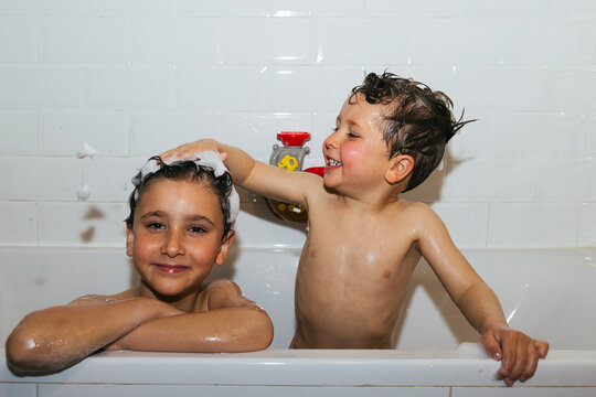 Happy children playing together during fun bath time