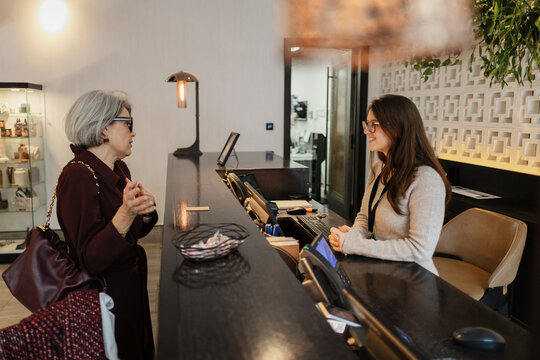 Client interacting with receptionist at hotel desk