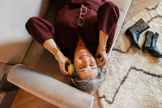 Senior woman enjoying music and relaxation at home