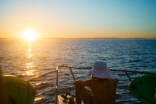 Child Watching Sunset From Boat
