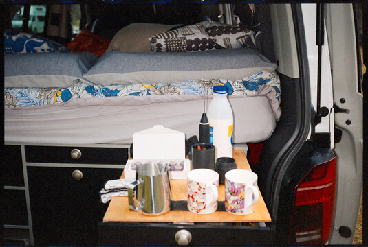 Coffee Preparation in a Camper Van During Morning Hours