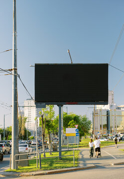 Traffic Flows Near a Large Blank Billboard in a City
