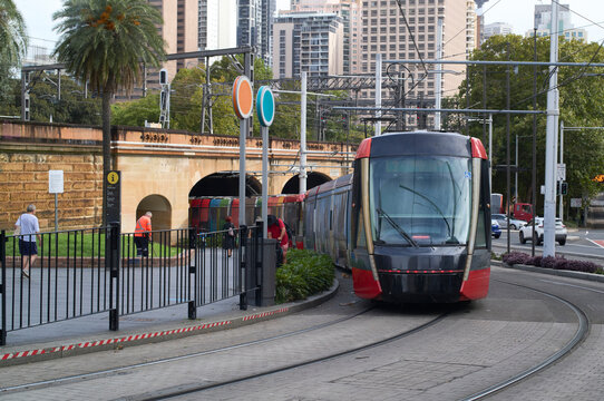 Modern Tram Travels Through City Streets of Sydney