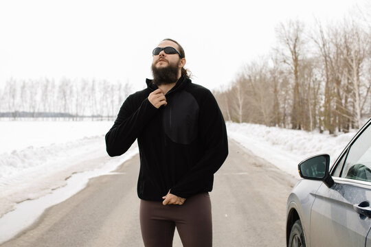 Man dress up near the car for training