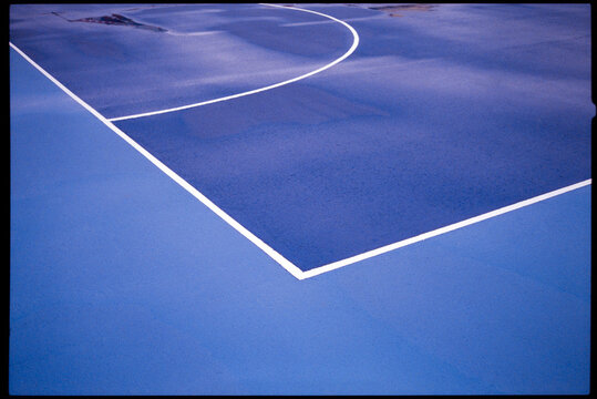 Damaged Basketball Court Surface With White Lines