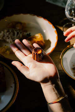 Anonymous woman's hand holding a traditional French dessert