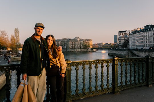 Portrait of a smiling couple of travelers posing in Paris