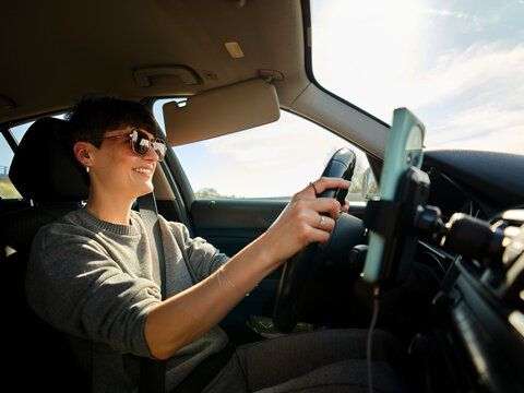 Woman driving car in Porto enjoying road trip