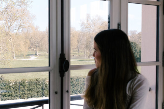 Young woman sitting on a window ledge at a rural hotel