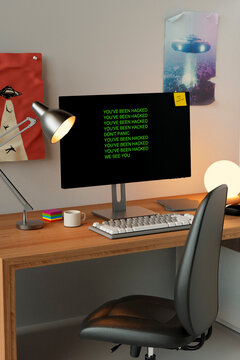 Home office desk with hacked computer display