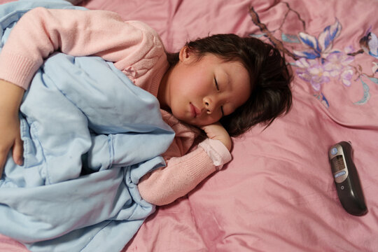 Sick Child Resting in Bed