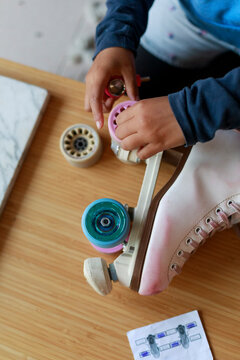 Roller Skate Wheels Get Changed on a Wooden Surface