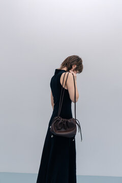 Back View Short Hair Black Dress Brown Leather Bag on Shoulder