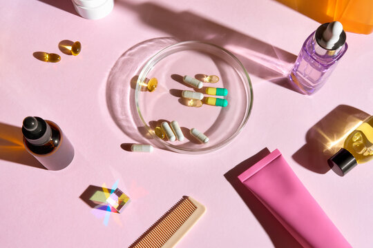 Beauty Products and Health Supplements Arranged on a Pink Surface