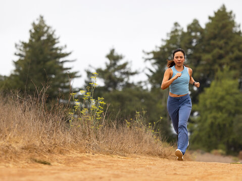 Asian fitness woman athlete  running outdoors alone