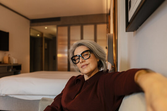Elegant senior womanen joying leisure time in a bedroom