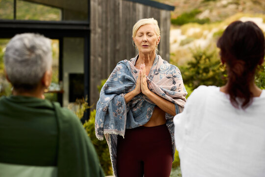 Women Practicing Yoga Outdoors in Nature