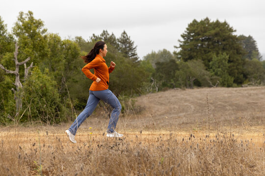 Asian woman athlete trail Running Fall