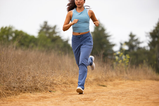 Asian fitness stride athlete  running outdoors alone
