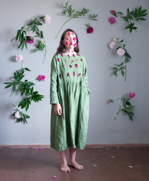Woman standed full body surrounded by flowers