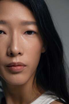 Asian individual with dark hair looking at camera