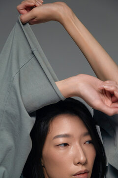 Person expressing emotion with minimal fashion studio attire