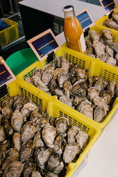 Fresh oysters in yellow crates at a Parisian market