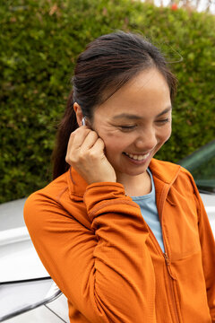 Pretty Asian fitness smile  Portrait with earbud 