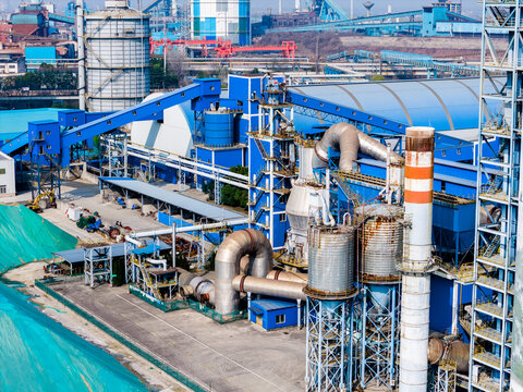 Industrial plant with blue structures and silos