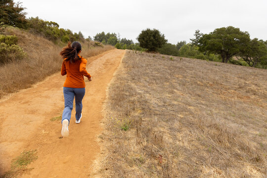 Asian fitness woman athlete trail Running alone