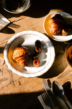 Traditional French desserts on ceramic plates, bathed in sunlight