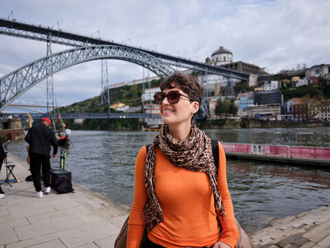 Woman traveling in Porto against river and bridge