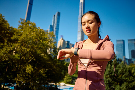 Active woman uses fitness tracker in New York City