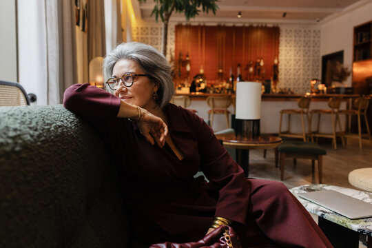 Sophisticated Senior woman relaxing in a luxurious hotel lounge