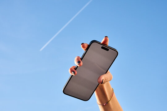 Smartphone in Hand, Blue Sky