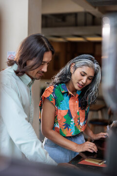 Couple looking at menu in restaurant.