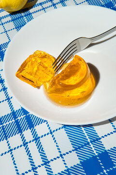 Summer picnic still life with jelly dessert on a checkered tablecloth.