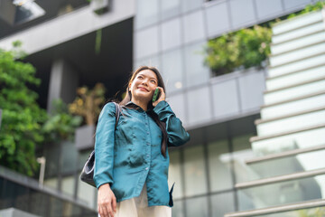 Fototapeta premium Asian woman talking on smartphone calling customer service, Female user contacting helpdesk support to solve problem, Telecommunication, call center, mobile phone network and remote assistance concept