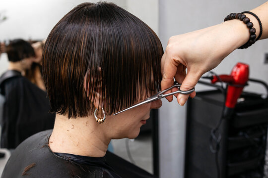 Woman gets haircut in salon during 