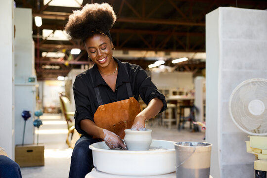 Afro rtist Makes Pottery in a Workshop Space