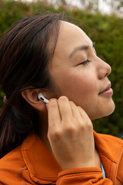 Pretty Asian fitness relax Portrait with music earbud 
