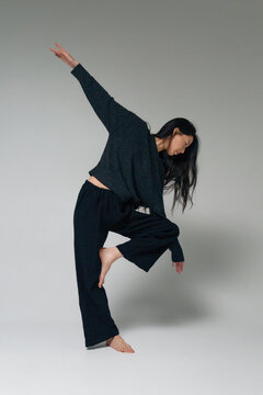 Person balancing on one leg in dance studio